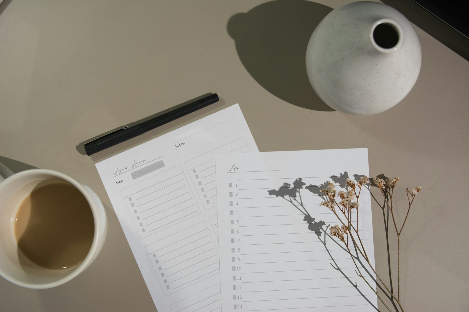 white printer paper beside white ceramic mug