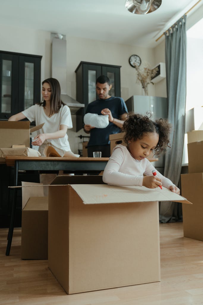 Naca mortgage. A family of three unpacking boxes in their new home, capturing the moving process.