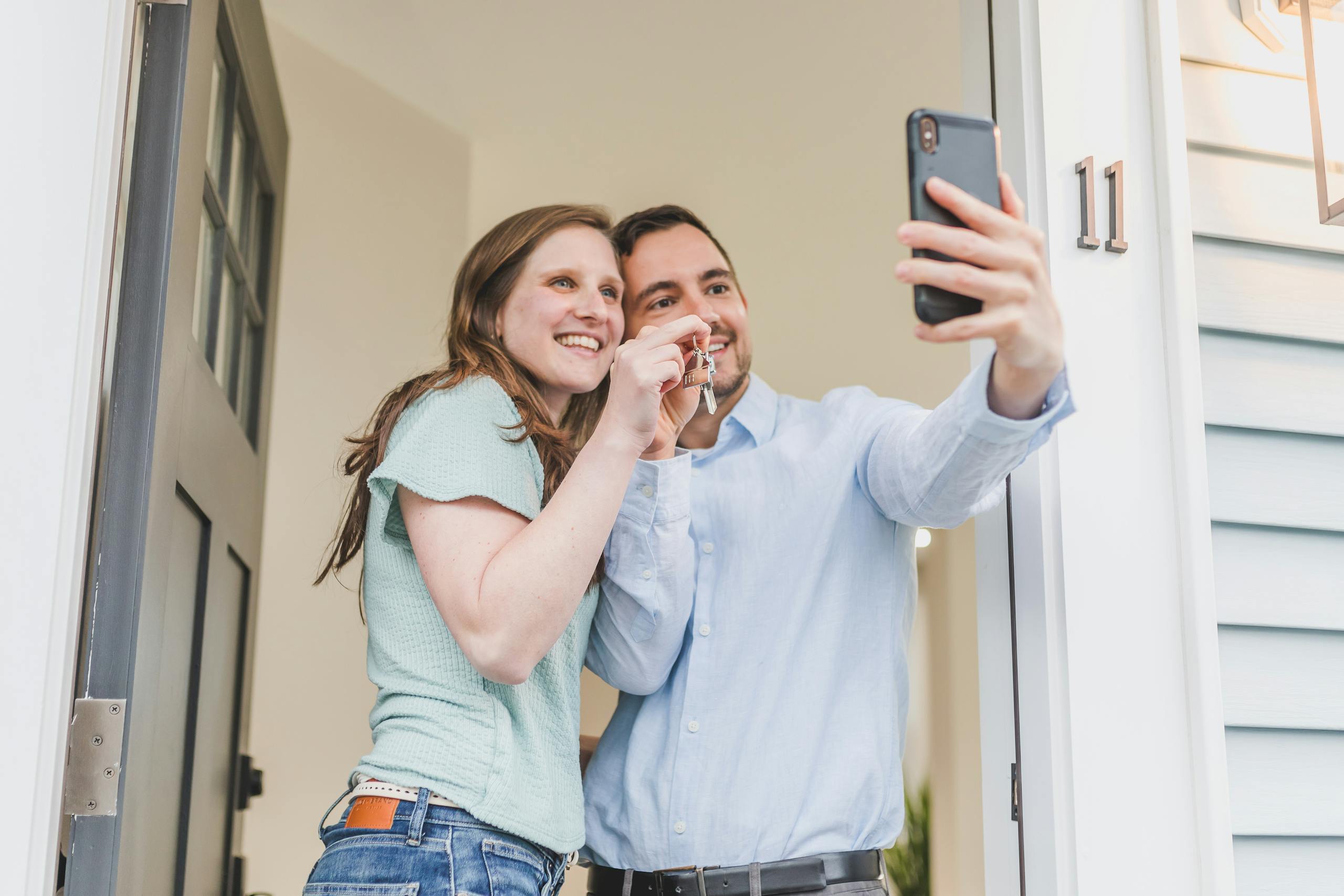 Florida Assist helps a happy couple takes a selfie while celebrating keys to their new home.