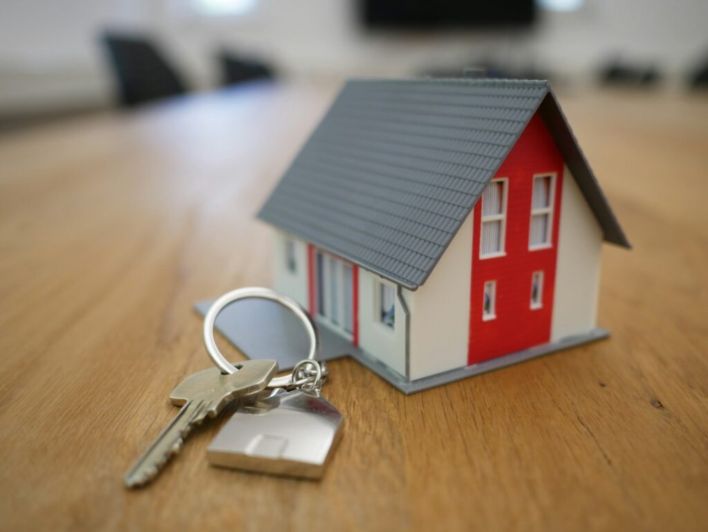 Naca mortgage. White and red wooden house miniature on brown table