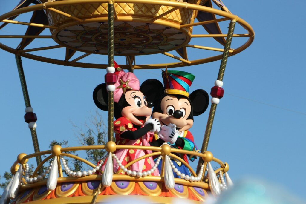 mickey and minnie mouse riding on swing ride